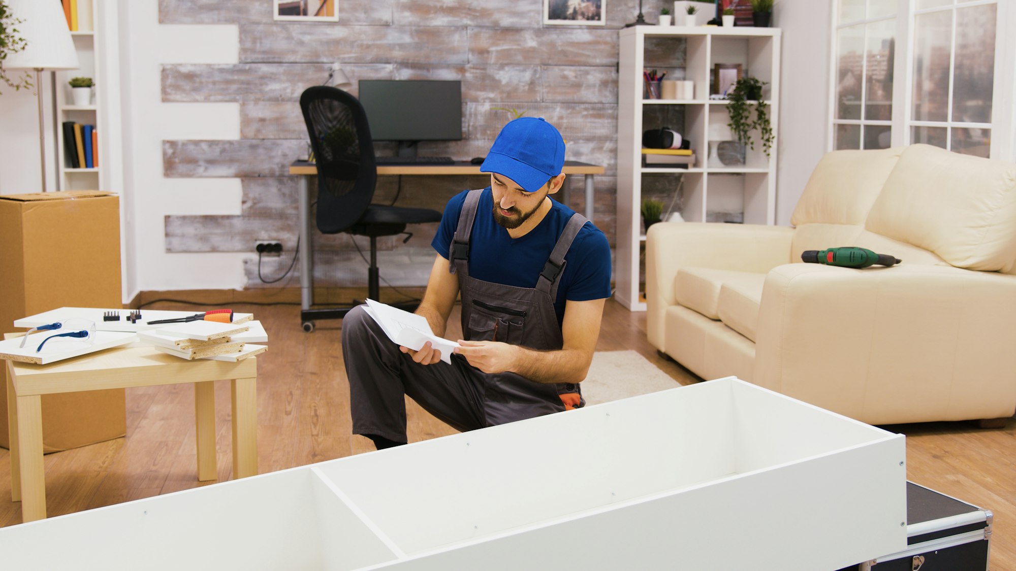 Furniture assembly worker using screwdriver